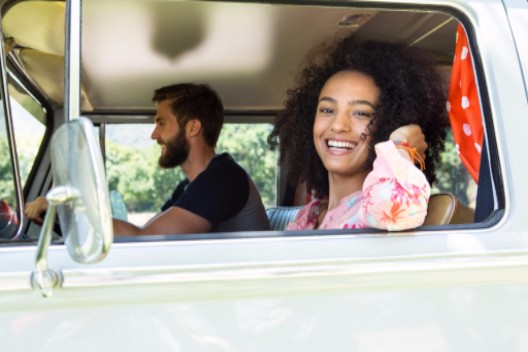 young couple driving in van: Classic Vans travel and camper vans article